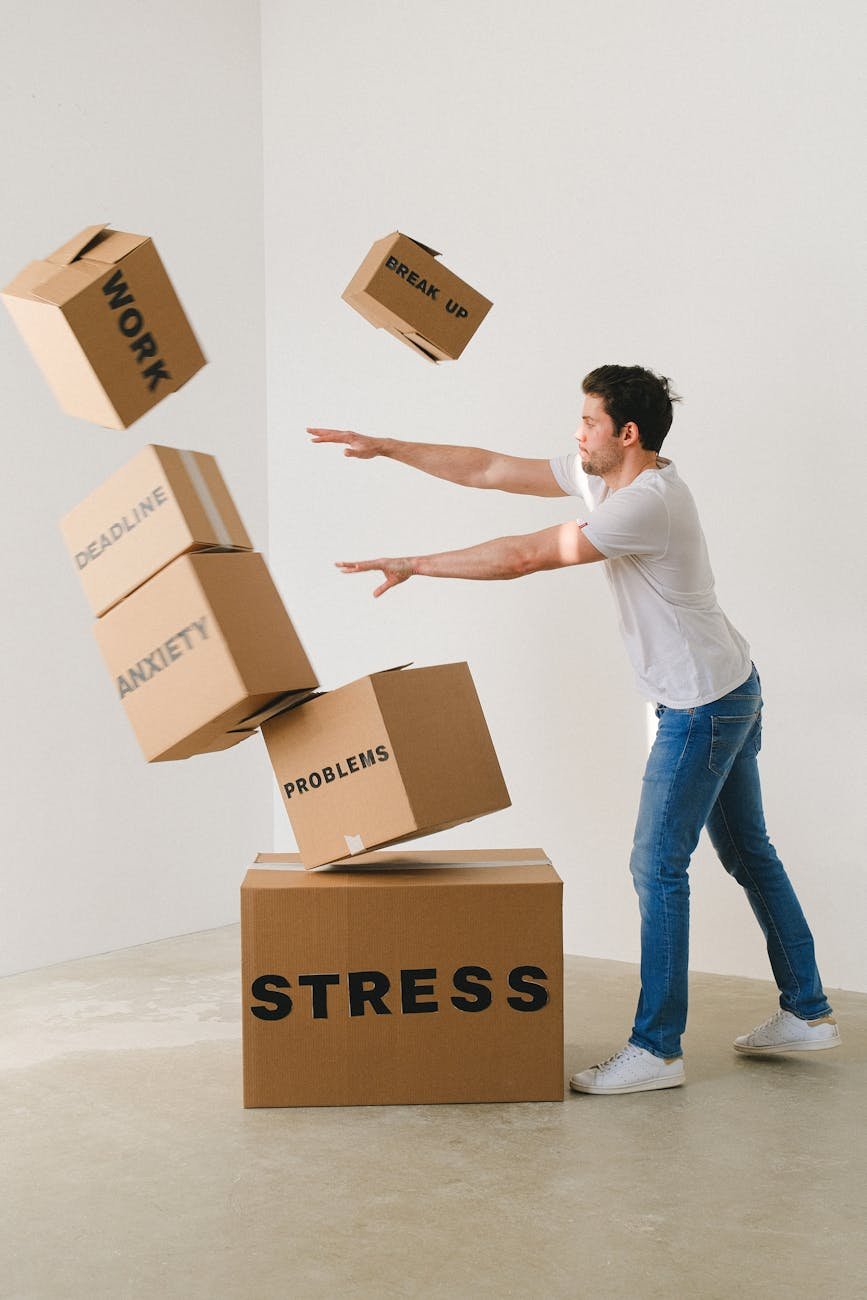 man falling carton boxes with negative words